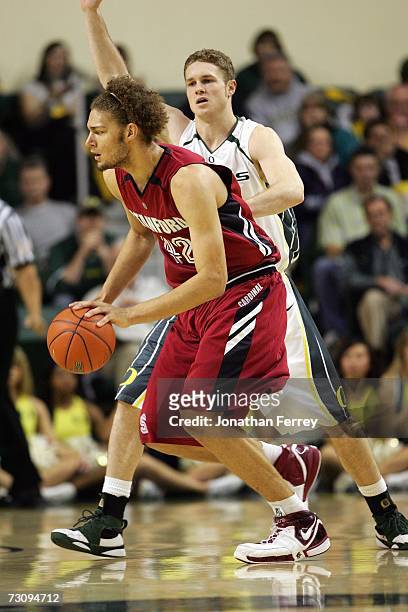 Robin Lopez of the Stanford Cardina drives to the basket against Maarty Leunen of the Oregon Ducks on January 18, 2007 at McArthur Court in Eugene,...