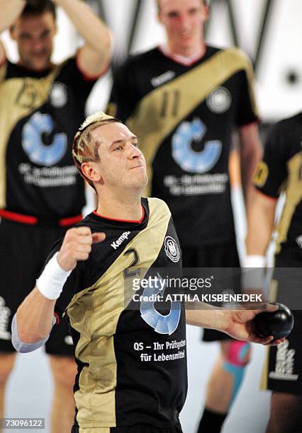 Germany's man of the match Pascal Hens celebrates their victory over Slovenia after their main round Group I match of the 2007 men's Handball World...