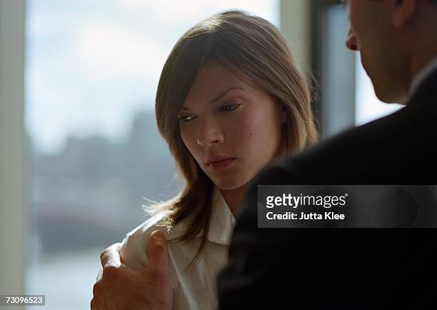 woman with man?s hand on her shoulder - rear view hand window stock pictures, royalty-free photos & images