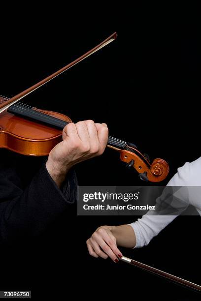 man playing a violin and a woman playing a cello - violin scroll stock pictures, royalty-free photos & images