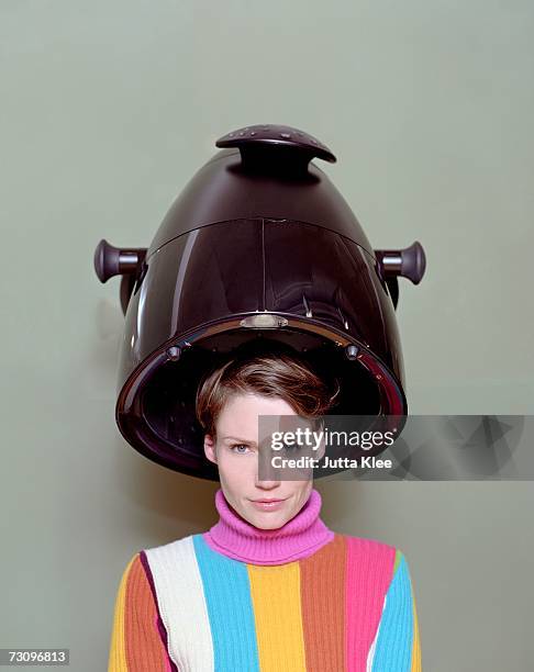 woman sitting under a hair dryer in a hair salon - vintage beauty salon stock pictures, royalty-free photos & images