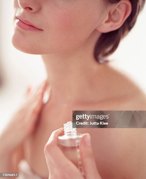 woman applying essential oil to skin - applying oil stock pictures, royalty-free photos & images