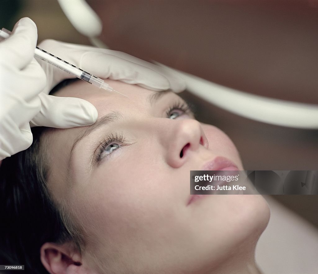 Woman receiving a neurotoxin injection injection