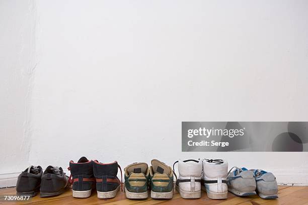 a row of trainers - shoes in a row stock pictures, royalty-free photos & images