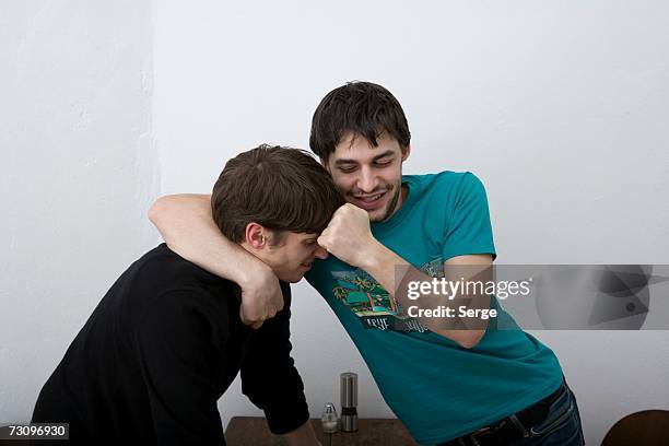 young men play fighting - prender a cabeça imagens e fotografias de stock