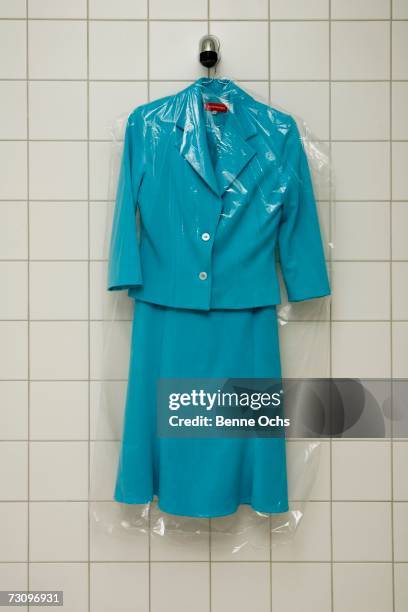 dry cleaned suit hanging in a shower - dry cleaning bag stock pictures, royalty-free photos & images