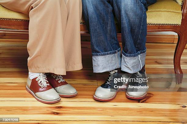 low section of two people sitting side by side in 1950?s style - rockabilly stock photos et images de collection