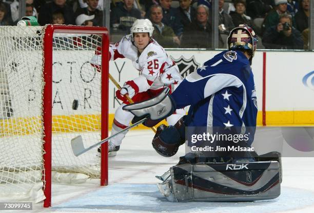 Eastern Conference All-Star Martin St. Louis of the Tampa Bay Lightning scores a goal past Western Conference goaltender Roberto Luongo of the...