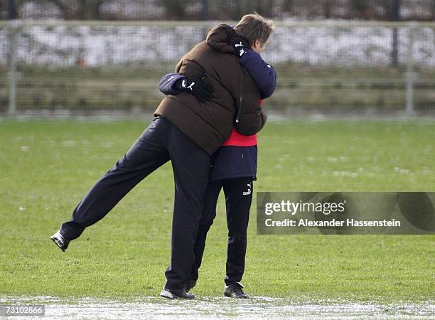 Thomas Doll , head coach of Hamburg, welcomes Dietmar Beiersdorfer , sporting Director of Hamburg, during the training session of Hamburger SV on...