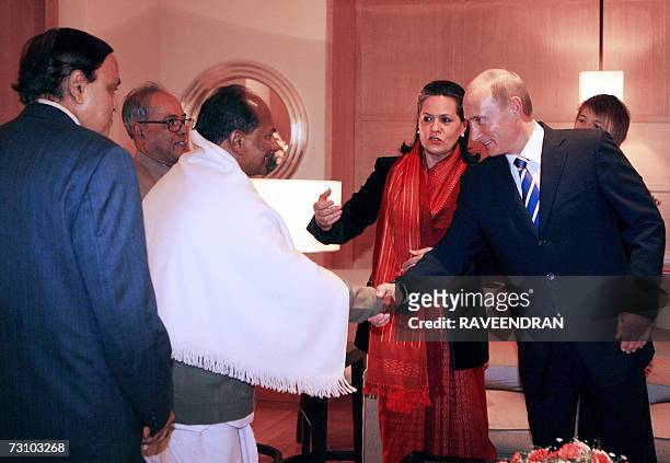 Russian President Vladimir Putin shakes hands with Indian Defence Minister A. K. Antony, as Chairperson of India's United Progressive Alliance...