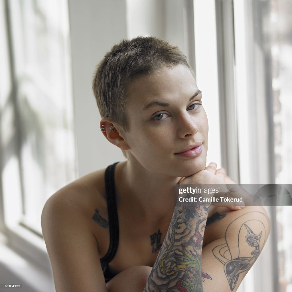 Young woman with tattoo on hand, portrait