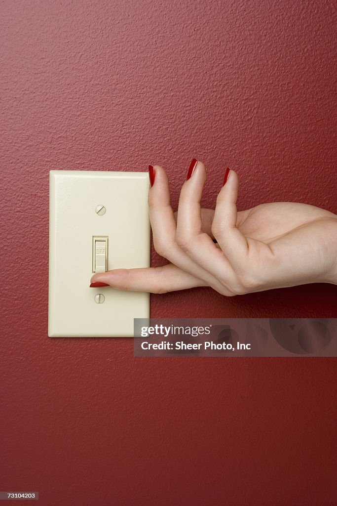 Womans Hand Turning Off An Electrical Wall Switch Closeup High-Res ...