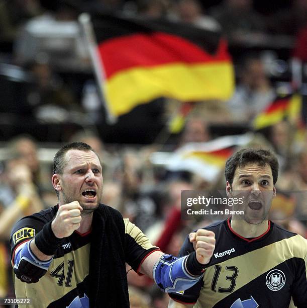 Christian Schwarzer and Markus Baur of Germany celebrate during the Men's Handball World Championship Group I game between Tunisia and Germany at the...