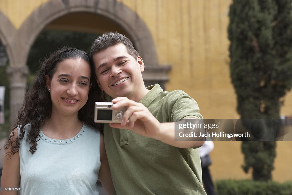 Close-up of a young couple smiling for a photograph