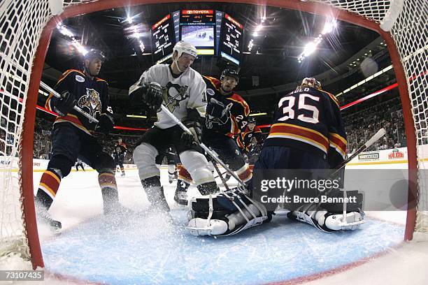 Jordan Staal of the Pittsburgh Penguins takes a shot on goaltender Alex Auld of the Florida Panthers as Ruslan Salei and Nathan Horton help defend...
