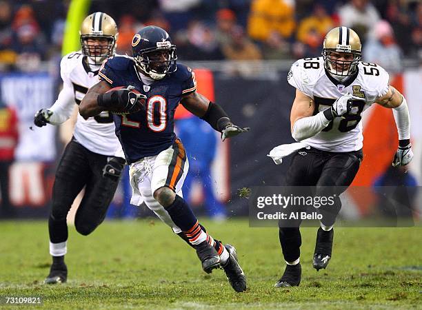 Running back Thomas Jones of the Chicago Bears runs for 33-yards against Scott Fujita and Scott Shanle of the New Orleans Saints during the second...