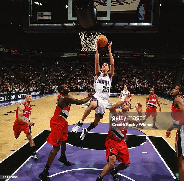 Kevin Martin of the Sacramento Kings drives to the basket for a layup against Zach Randolph and Ime Udoka of the Portland Trail Blazers during a game...
