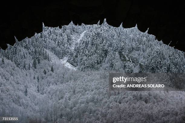 Shadow covers a snowed mountains near Viganella's village in Italian Alps, 24 January 2007. AFP PHOTO / ANDREAS SOLARO