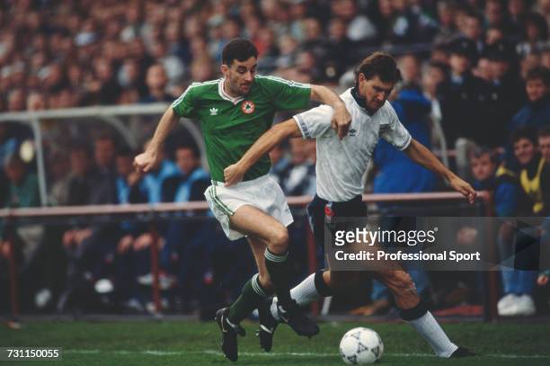 John Aldridge of the Republic of Ireland team attempts to tackle English defender Tony Adams for the ball during the UEFA European Championship...