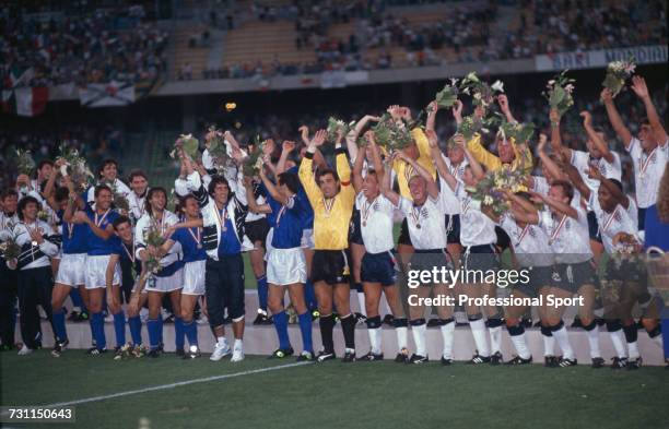 View of players from Italy and England teams pictured with their medals partaking in a mexican wave celebration at the end of the third place match...