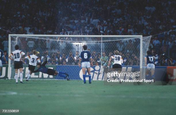 West German footballer Andreas Brehme scores from the penalty spot in the 85th minute of the 1990 FIFA World Cup Final between West Germany and...