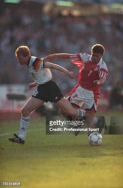 German footballer Matthias Sammer clashes with Danish footballer John Jensen during the final of the UEFA Euro 1992 Championship tournament between...
