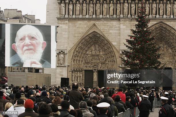 Portrait of the Abbe Pierre is seen on a giant screen during a mass held during his funeral in Notre Dame Cathedral on January 26, 2007 in Paris,...