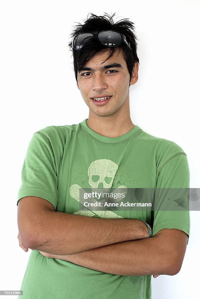 Teenage boy (15-17) with arms crossed, portrait