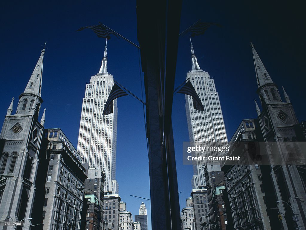 USA, New York City, Empire State Building reflected in store window