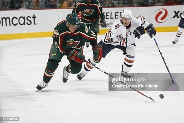 Marian Gaborik of the Minnesota Wild skates past Joffrey Lupul of the Edmonton Oilers during the game at Xcel Energy Center on January 16, 2007 in...