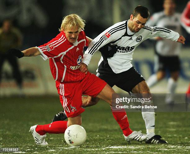 Michael Wiesinger of Burghausen and Pekka Lagerblom of Cologne battle for the ball during the Second Bundesliga match between Wacker Burghausen and...