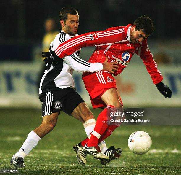 Michael Wiesinger of Burghausen is challenged by Fabrice Ehret of Cologne during the Second Bundesliga match between Wacker Burghausen and 1. FC...