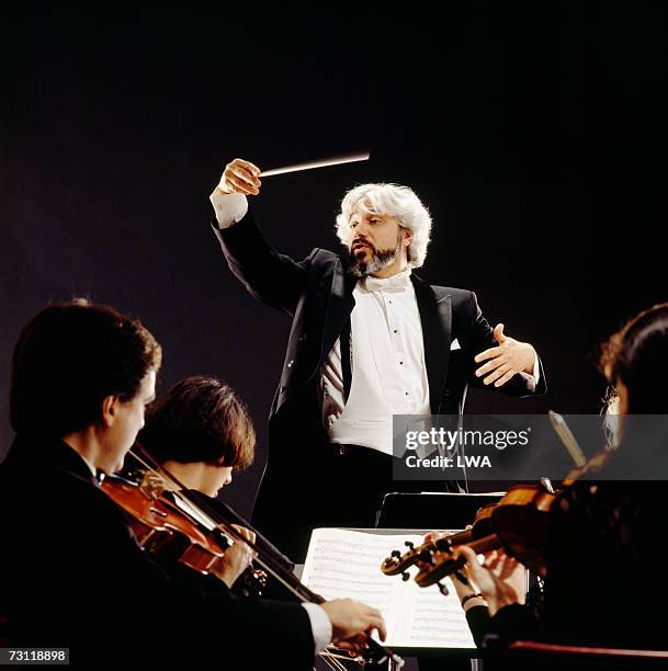 man conducting orchestra, view from violin section - orchestra conductor foto e immagini stock