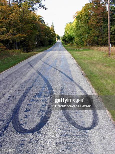 road with tire marks on surface - sked stock pictures, royalty-free photos & images