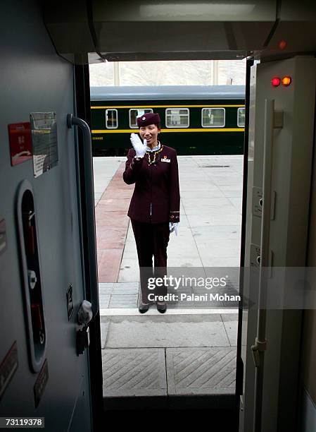 Chinese train stewardess waves as the new Qinghai- Tibet train gets ready to leave Lhasa station on July 11, 2006 in Lhasa, China. On July 2nd 2006...