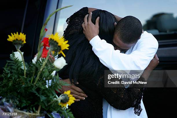 Family members hug as they exit the back of the courthouse after nine black youths, eight girls and one boy, were convicted of taking part in the...
