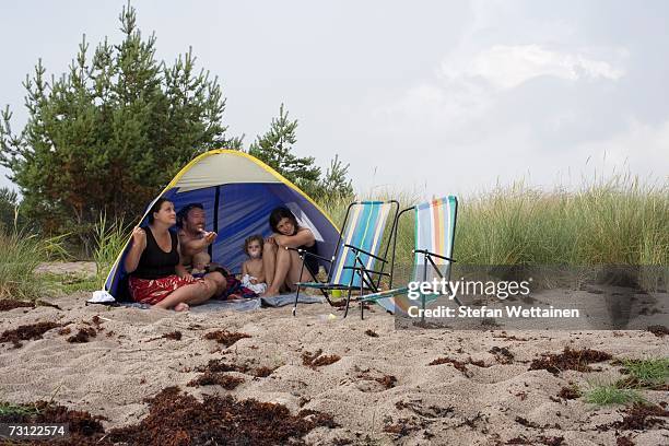 a family in a tent on a beach. - the comedy tent stock pictures, royalty-free photos & images