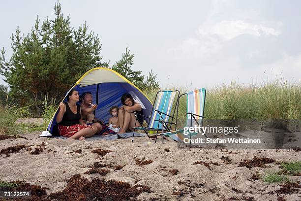 a family in a tent on a beach. - svensk sommar bildbanksfoton och bilder