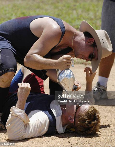 Davey Rowllison of the team 'Joes' recieves a 'layback' from teammate Doug Babarovich during the Goldfield Ashes January 27, 2007 in Charters Towers,...