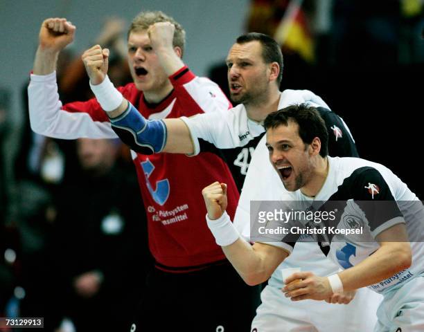 Johannes Bitter, Christian Schwarzer and Markus Baur of Germany celebrates a goal during the Men's Handball World Championship Group I game between...