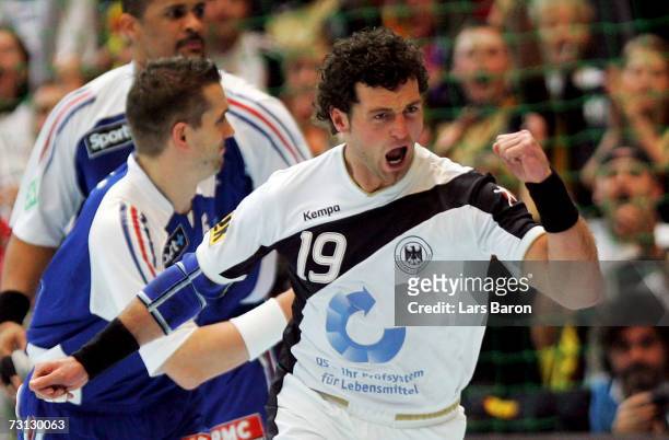 Florian Kehrmann of Germany celebrates scoring a goal during the Men's Handball World Championship Group I game between Germany and France at the...