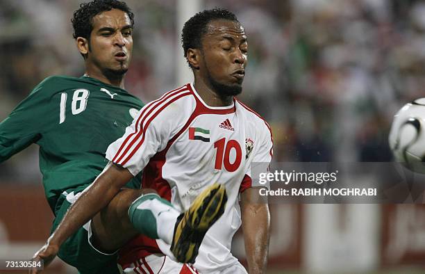 Abu Dhabi, UNITED ARAB EMIRATES: Emirati player Ismail Matar fights for the ball with Saudi player Abdo Oteif during their 18th Gulf Cup semi-final...