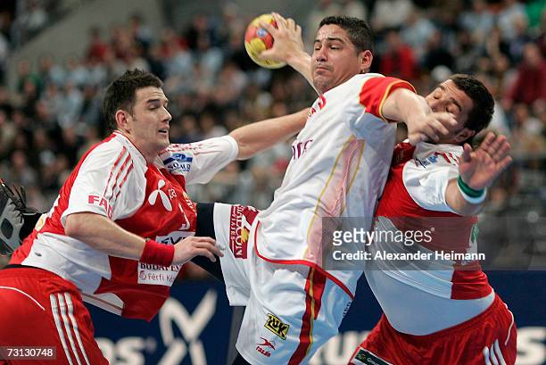 Ferenc Ilyes and Gyula Gal of Hungary compete with Rolando Fonseca of Spain during the Men's World Championship Group II game between Hungary and...