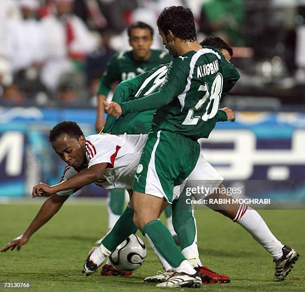 Abu Dhabi, UNITED ARAB EMIRATES: Emirati player Ismail Matar vies with Saudi players Badr Al Hakbani and Saleh Al Saqri during their 18th Gulf Cup...