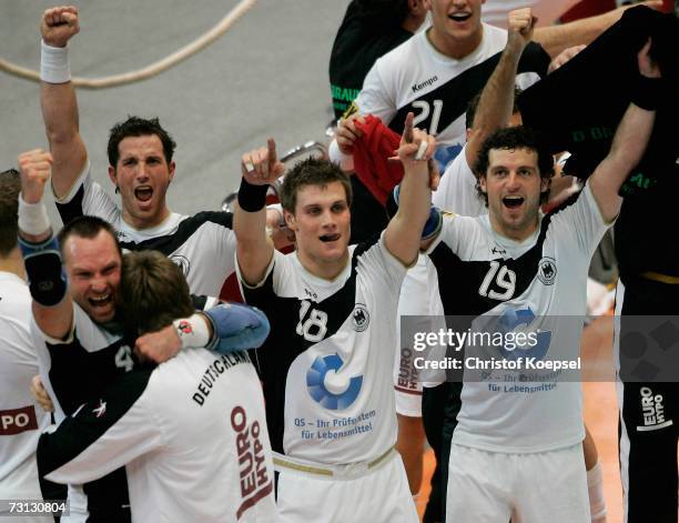 Christian Schwarzer, Michael Kraus and Florian Kehrmann of Grmany celebrates 29-26 victory of the Men's Handball World Championship Group I game...