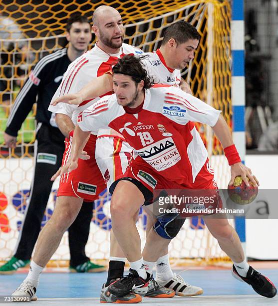 Attila Vatkerti and Laszlo Nagy of Hungary compete with Rolando Fonseca of Spain during the Men's World Championship Group II game between Hungary...