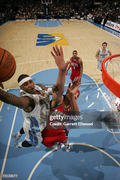 Carmelo Anthony of the Denver Nuggets goes to the basket against Josh Boone of the New Jersey Nets on January 27, 2007 at the Pepsi Center in Denver,...