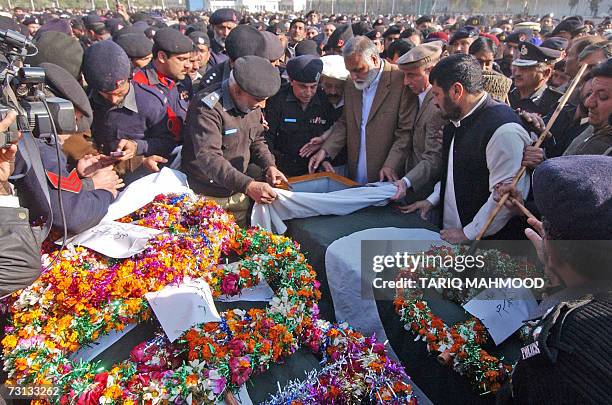 Pakistani Chief Minister of North West Frontier province Akram Khan Durrani takes the last glimpse of a senior police officer before his burial a day...