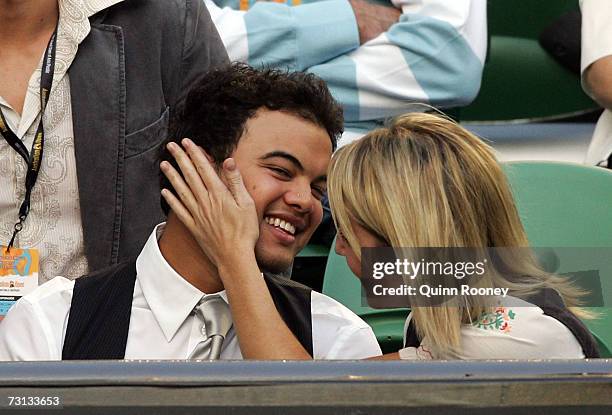 Singer Guy Sebastian and partner Julie Egan watch the men's final match between Fernando Gonzalez of Chile and Roger Federer of Switzerland on day...