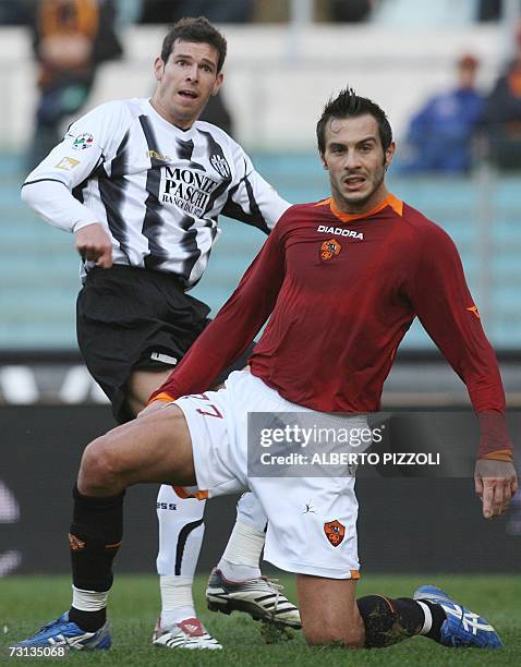 Roma defender Marco Cassetti looks at the ball with Liechtenstein forward Mario Frick of AC Siena during their Italian Serie A football match at...